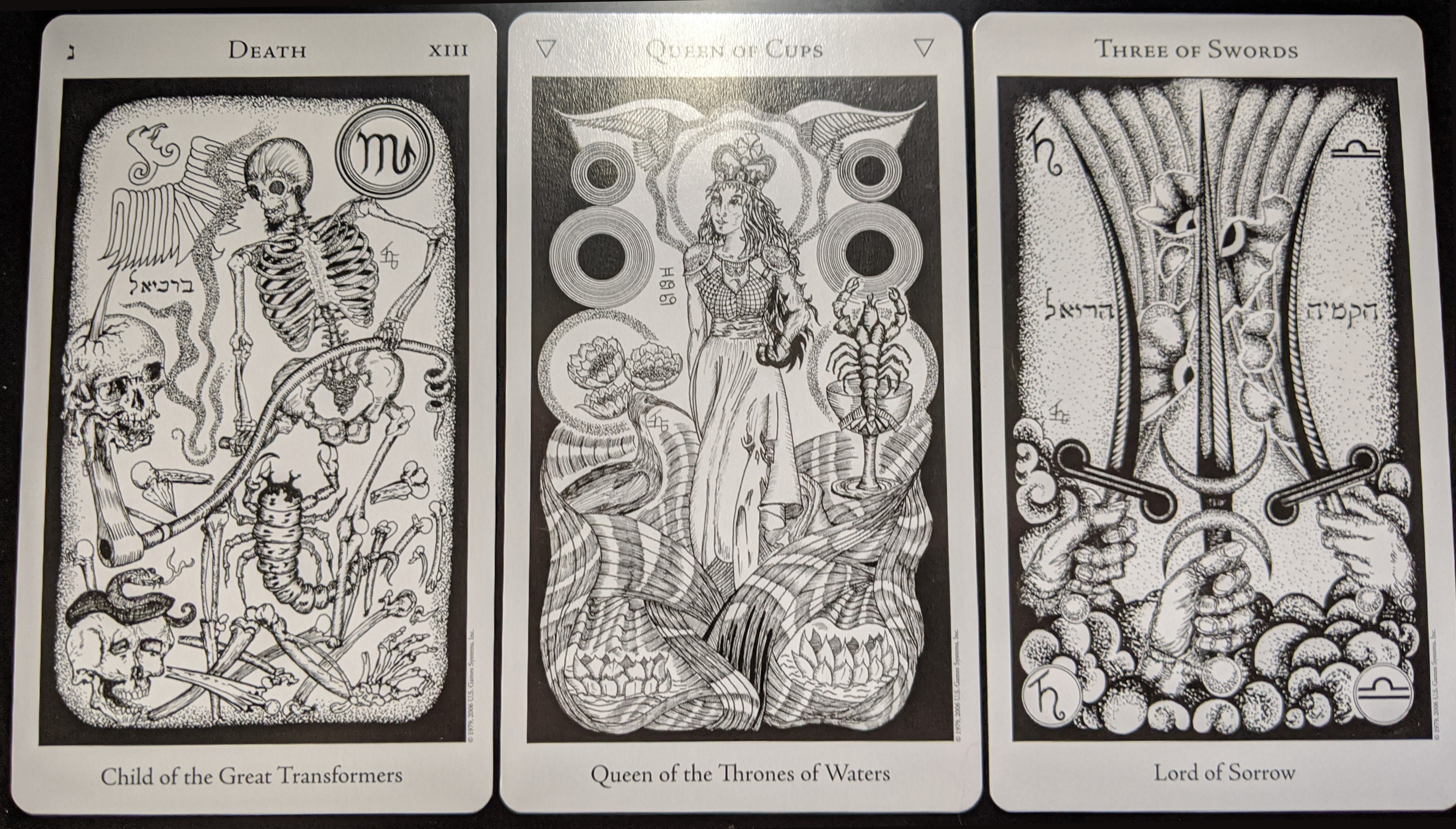 [Pictured: Death, the Queen of Cups, and the Three of Swords from the Hermetic Tarot.]
